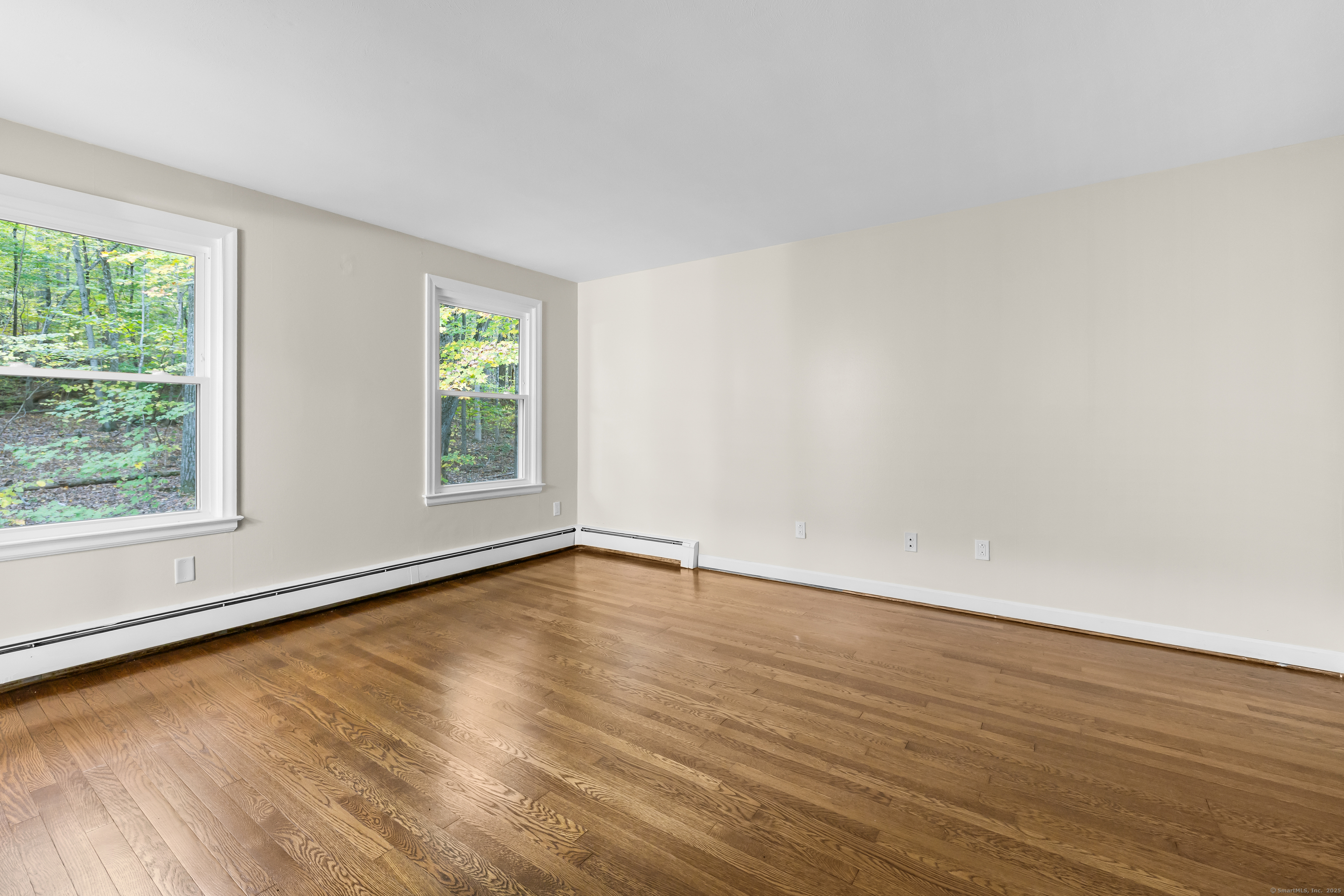 545 Simsbury Road Bloomfield, CT 06002 - Photo 26 of 39 a view of an empty room with wooden floor and a window