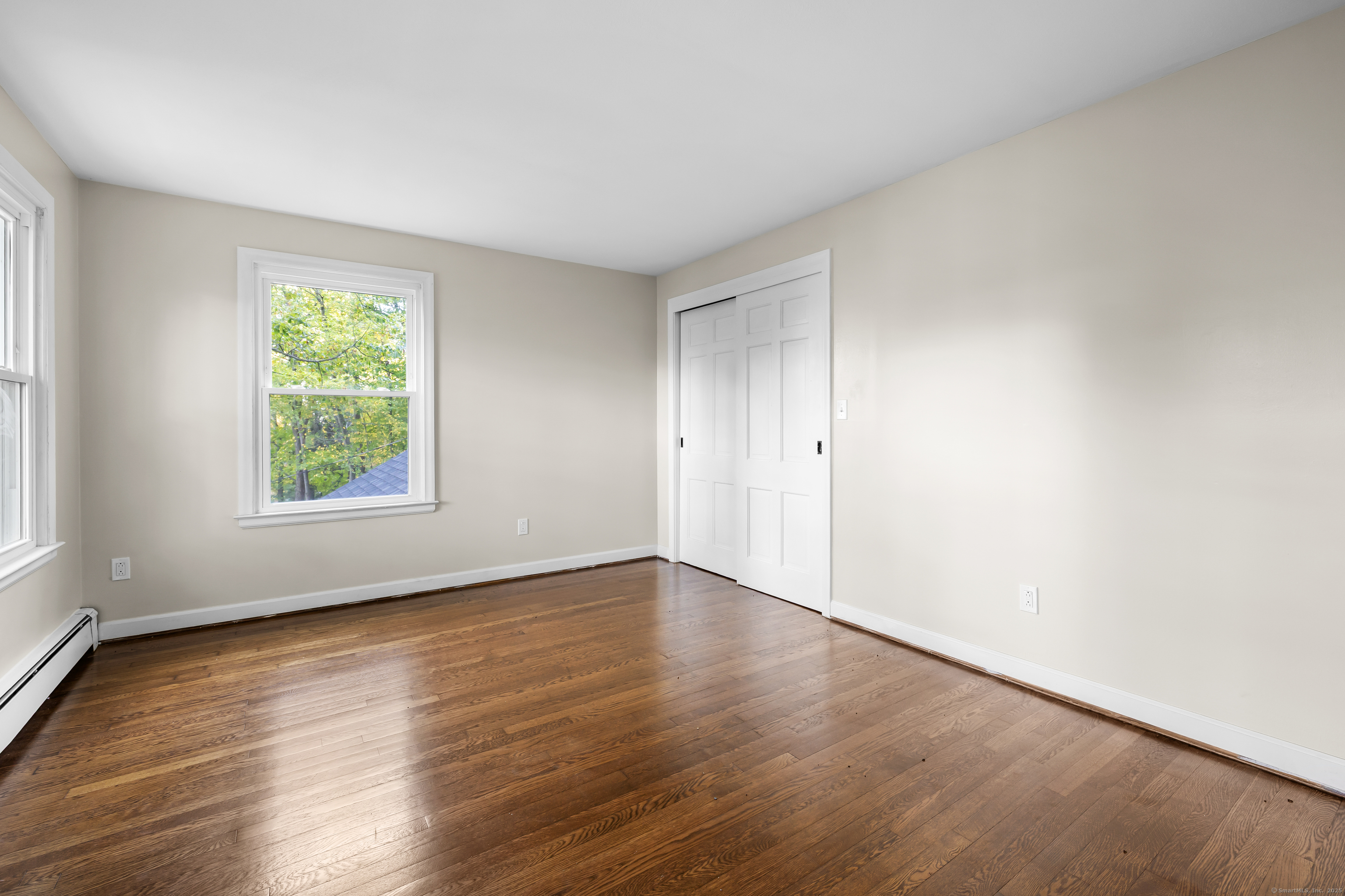 545 Simsbury Road Bloomfield, CT 06002 - Photo 31 of 39 an empty room with wooden floor and windows