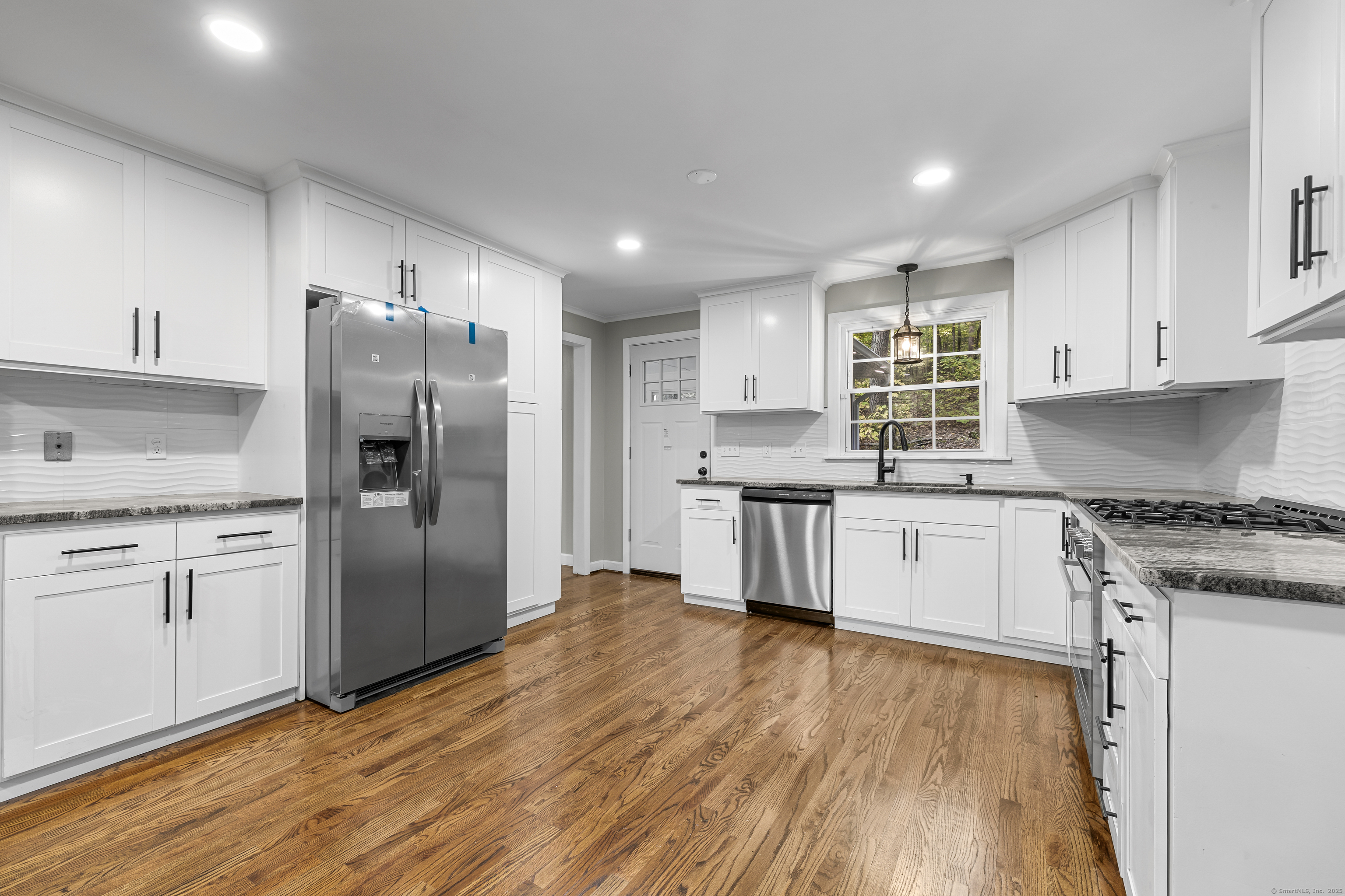 545 Simsbury Road Bloomfield, CT 06002 - Photo 7 of 39 a kitchen with granite countertop a refrigerator stove top oven and sink