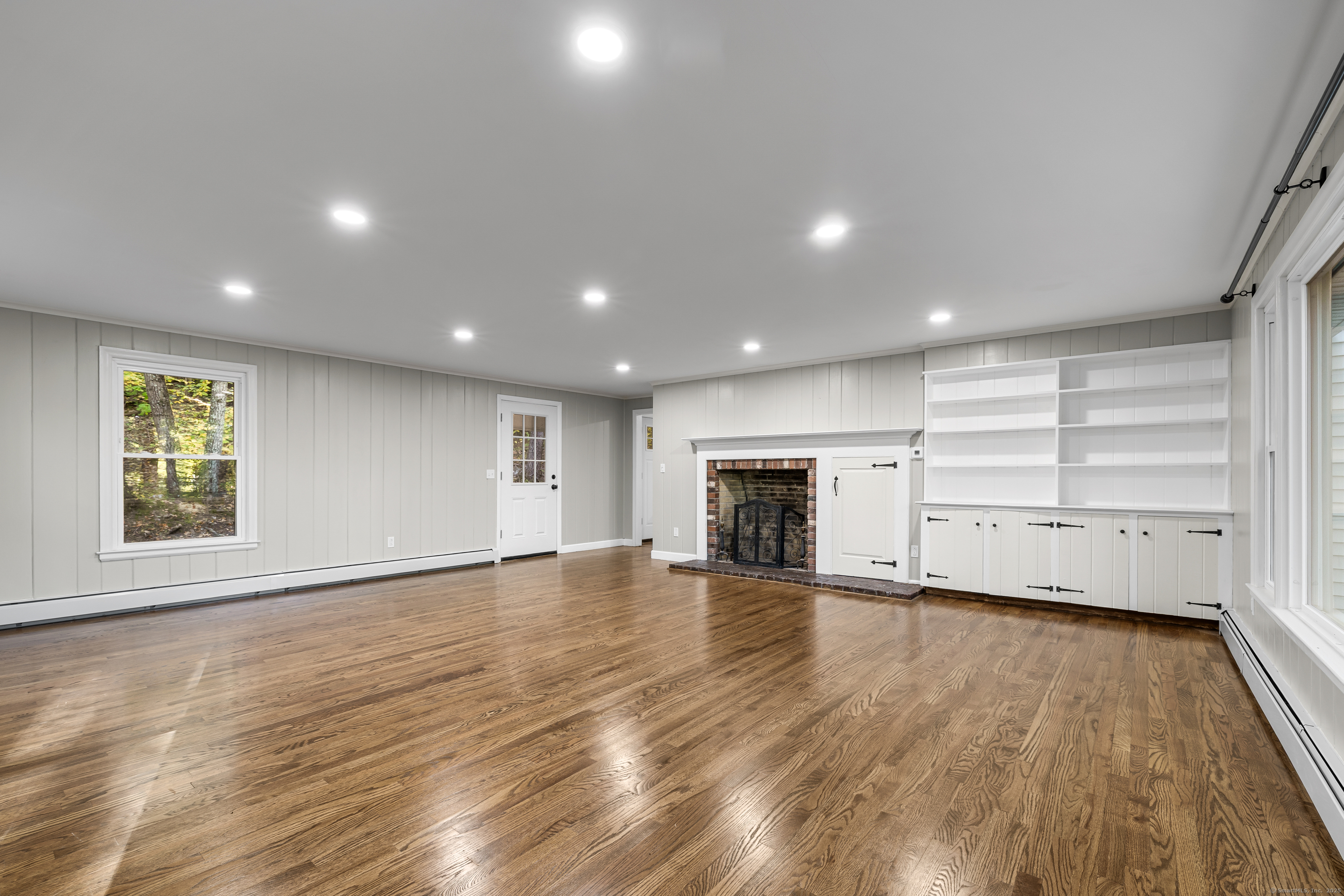 545 Simsbury Road Bloomfield, CT 06002 - Photo 10 of 39 an empty room with wooden floor closet and windows