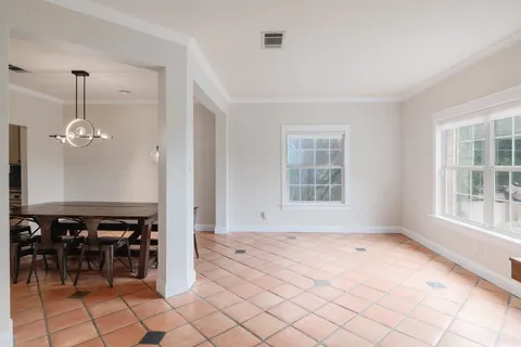 an empty room with windows and chairs