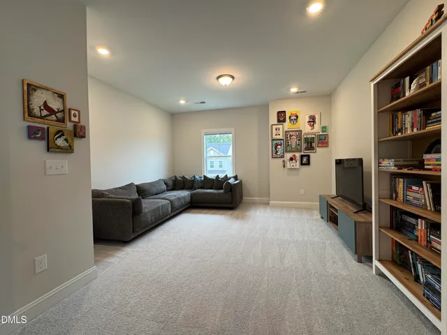 a view of a hallway with wooden floor and livingroom