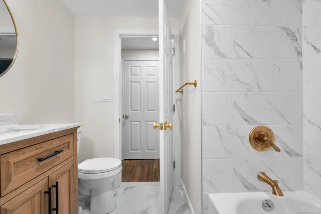 a bathroom with a sink toilet and shower