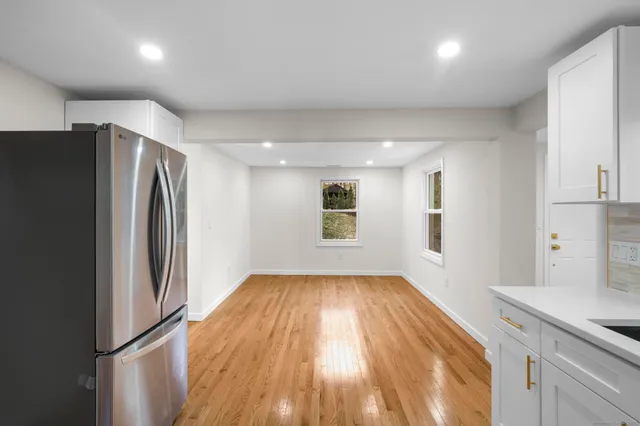 a view of a kitchen with a sink and refrigerator