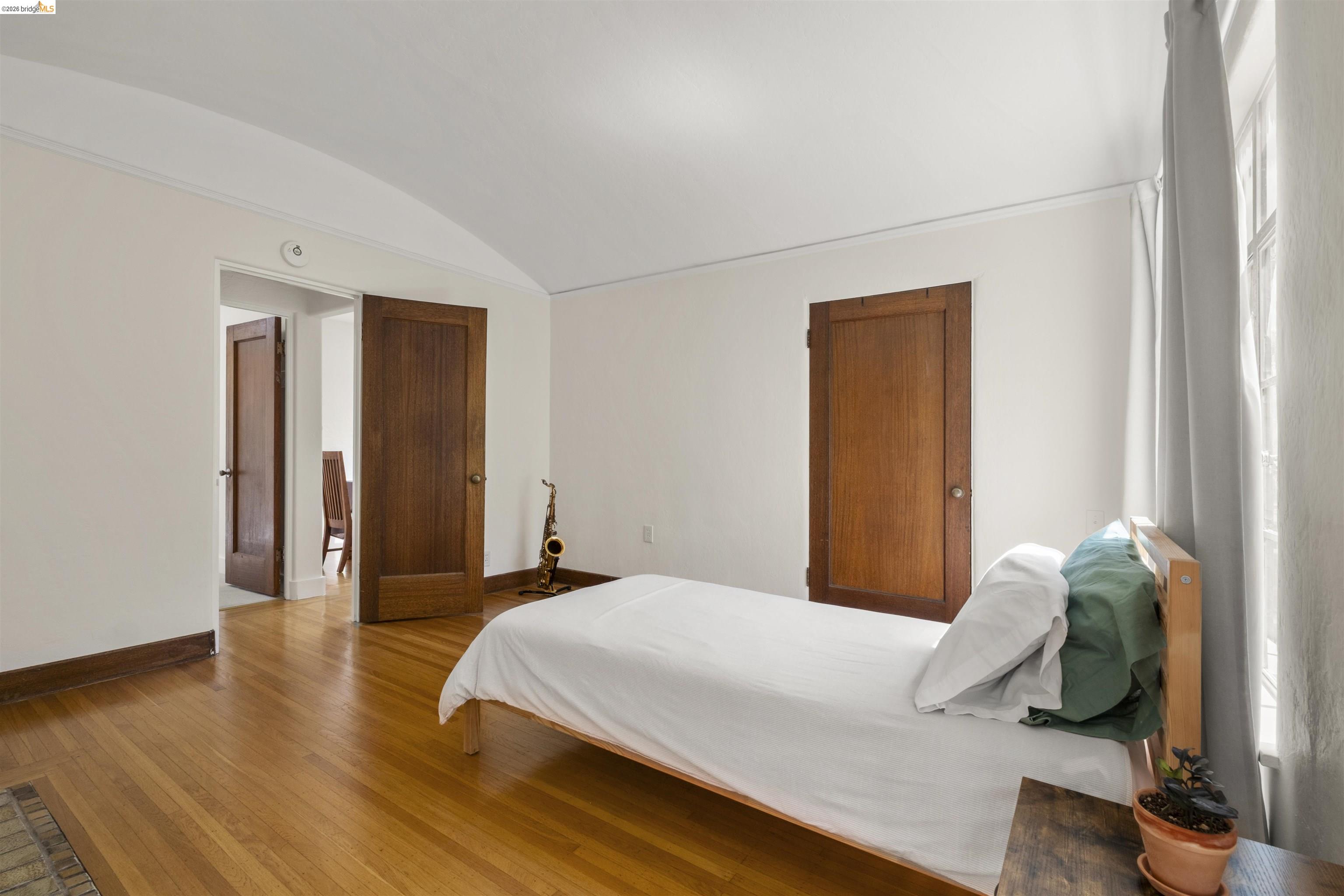 2444 Virginia Street, Unit B Berkeley, CA 94709 - Photo 28 of 39 Bedroom featuring wood-finish flooring, white walls, and a window with natural light