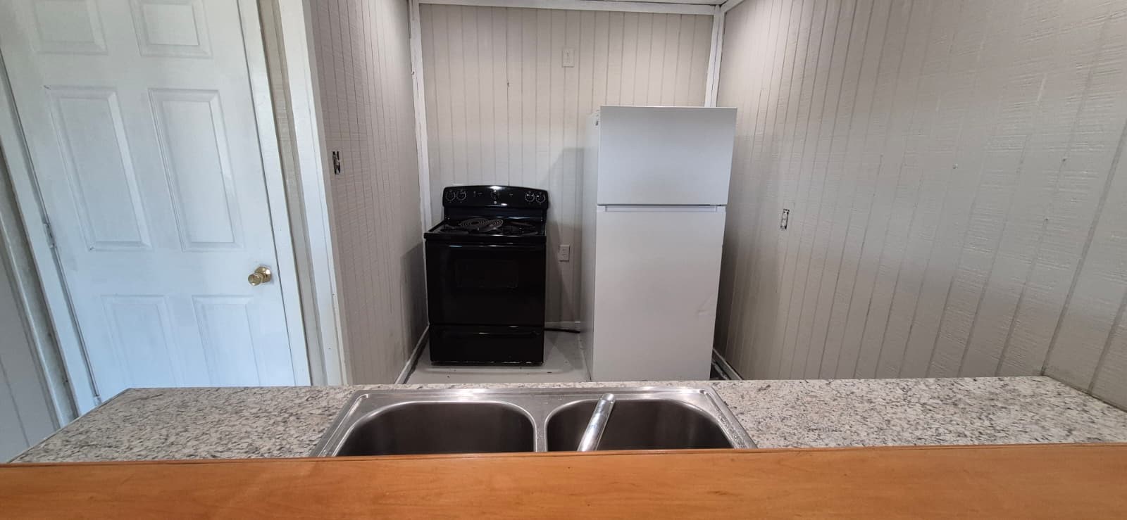 18530 Brumbelow Road Needville, TX 77461 - Photo 3 of 7 Compact kitchen featuring sleek cabinetry for efficient storage.