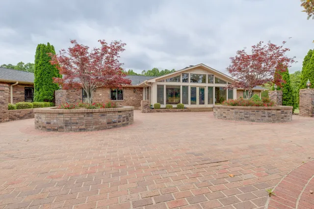 a front view of a house with a yard and trees