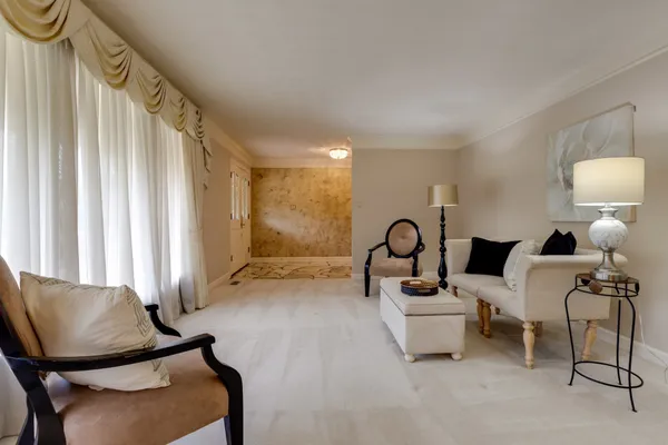 a living room with furniture a lamp and a window