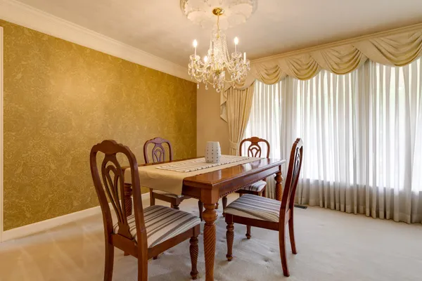 a view of a dining room with furniture and chandelier