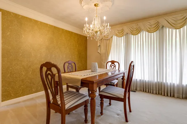 a view of a dining room with furniture and chandelier