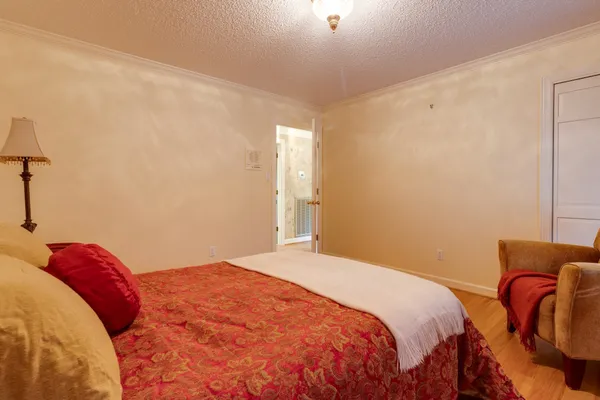 a bedroom with a bed and with a bathtub