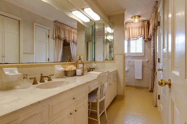 a spacious bathroom with a double vanity sink mirror and double