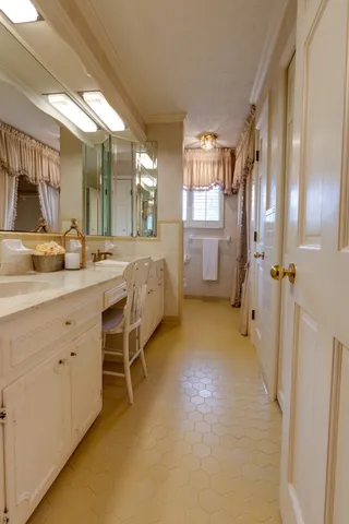 a spacious bathroom with a double vanity sink a mirror and a shower