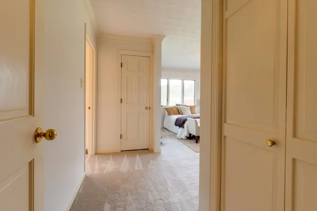 a spacious bedroom with a bed and a window