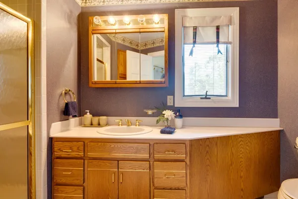a bathroom with a toilet sink and mirror