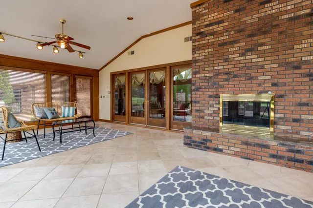 a view of a room with chairs and wooden floor