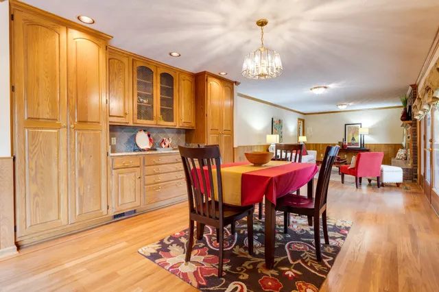 a view of a dining room with furniture and chandelier