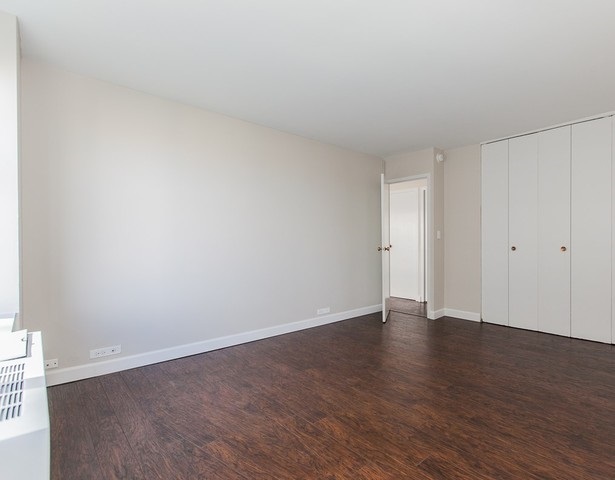 5757 North Sheridan Road, Unit 9C Chicago, IL 60660 - Photo 12 of 25 a view of an empty room with wooden floor