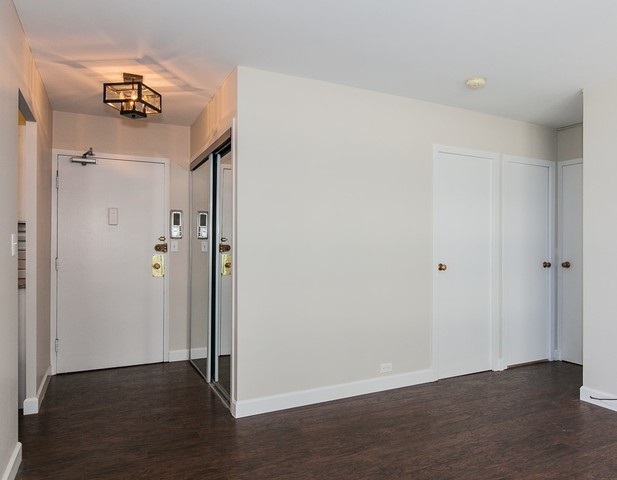 5757 North Sheridan Road, Unit 9C Chicago, IL 60660 - Photo 14 of 25 a view of a hallway with wooden floor