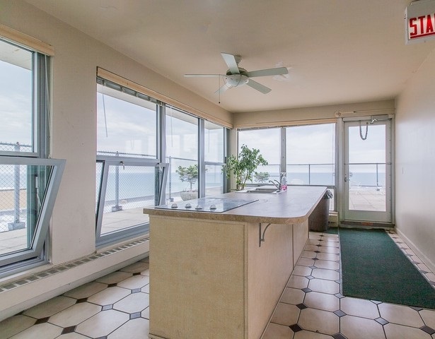 5757 North Sheridan Road, Unit 9C Chicago, IL 60660 - Photo 23 of 25 a dining hall with stainless steel appliances granite countertop a refrigerator a sink a window and a dining table