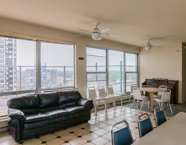 5757 North Sheridan Road, Unit 9C Chicago, IL 60660 - Photo 24 of 25 a living room with furniture and large windows