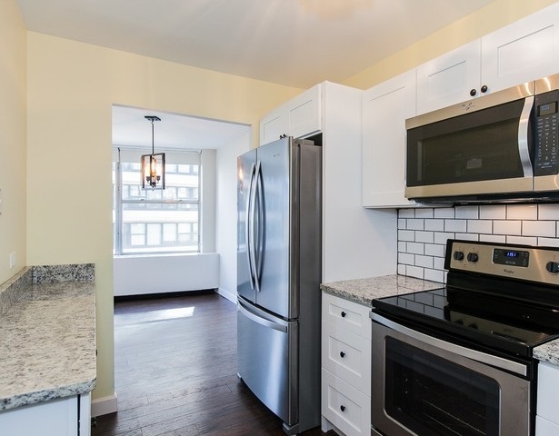 5757 North Sheridan Road, Unit 9C Chicago, IL 60660 - Photo 3 of 25 a kitchen with stainless steel appliances a stove microwave and refrigerator