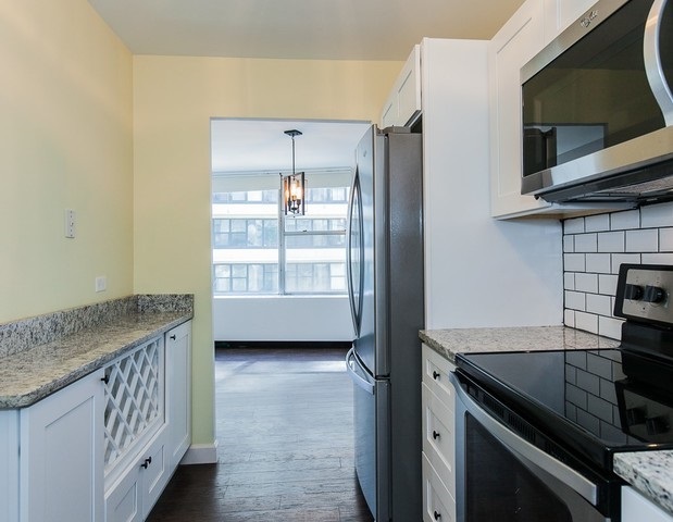 5757 North Sheridan Road, Unit 9C Chicago, IL 60660 - Photo 5 of 25 a kitchen with a sink a stove and cabinets