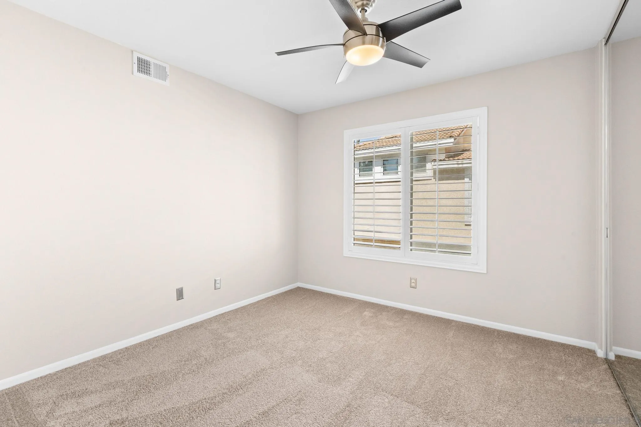 9338 Babauta Road, Unit 78 San Diego, CA 92129 - Photo 13 of 26 an empty room with a window and a ceiling fan