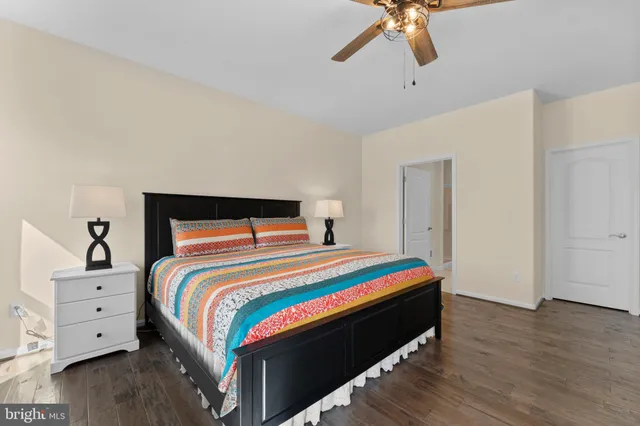 a bedroom with bed and a chandelier