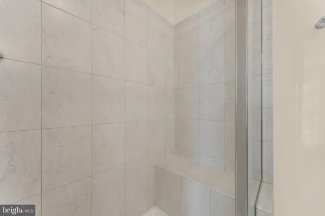 a bathroom with a sink a mirror and shower