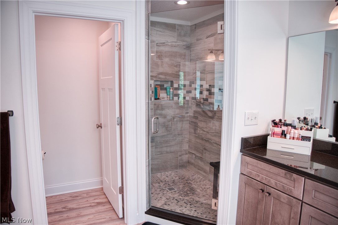 4553 Sharon Copley Road Medina, OH 44256 - Photo 10 of 32 Glass-enclosed shower featuring a tiled surround, accent tile band, and built-in bench