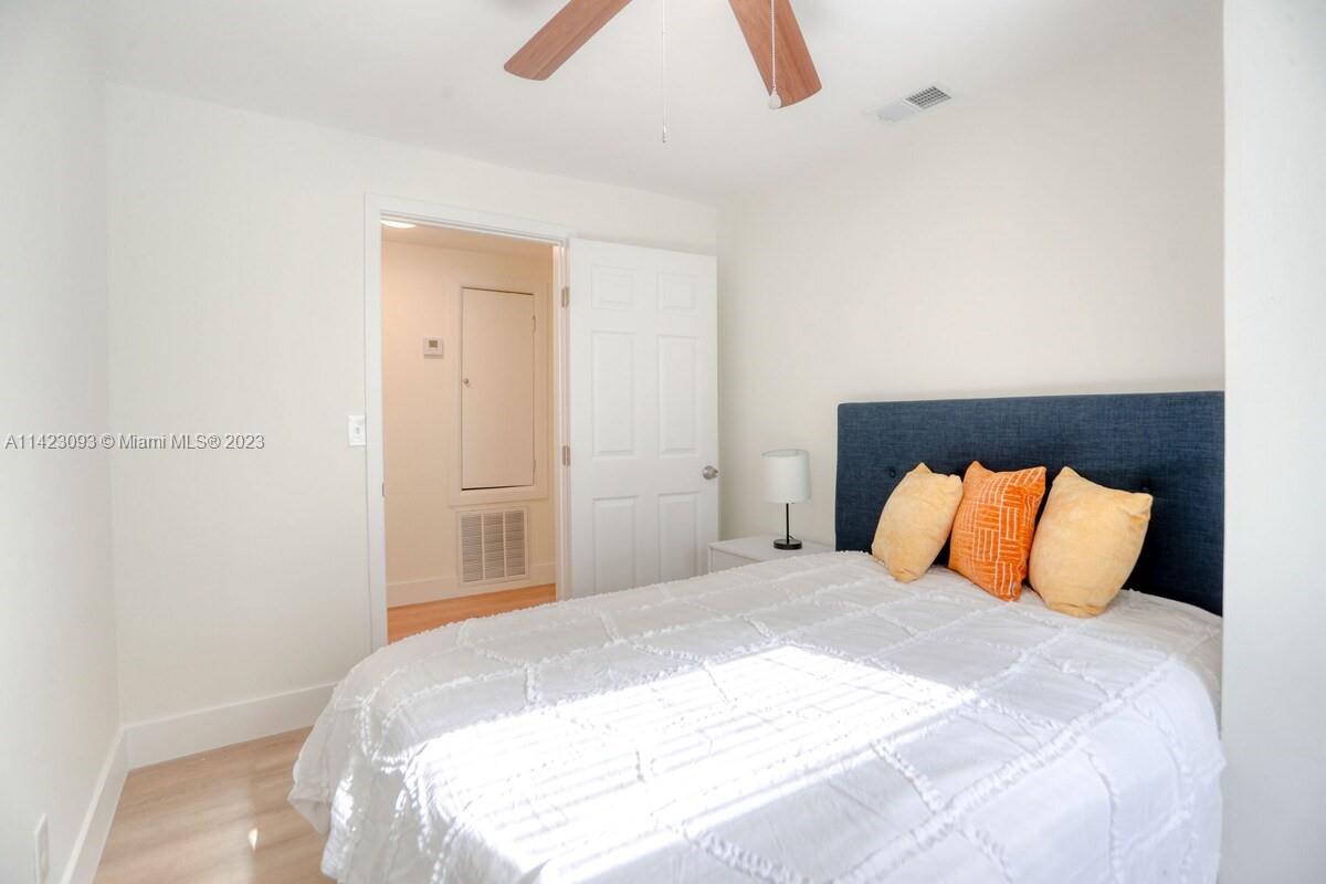 3632 Thomas Avenue Miami, FL 33133 - Photo 11 of 20 a bedroom with a bed and a lamp