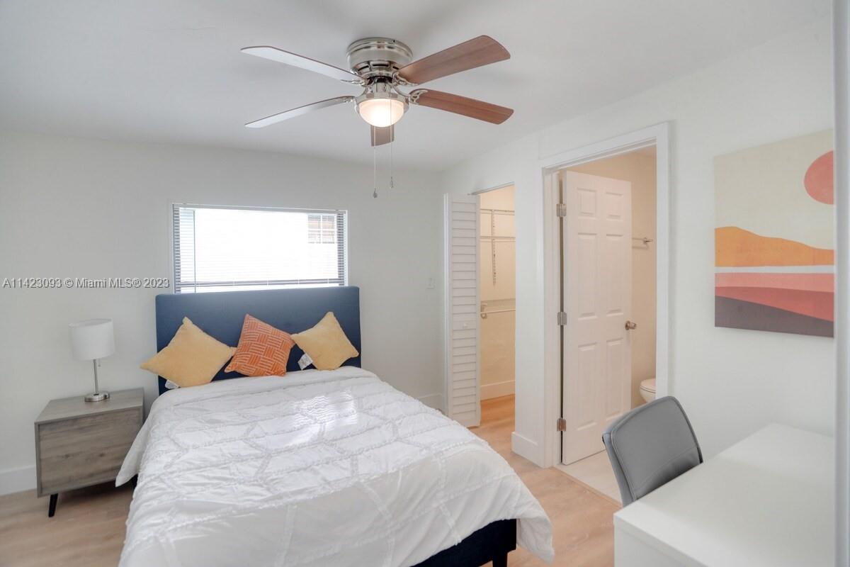 3632 Thomas Avenue Miami, FL 33133 - Photo 13 of 20 a bedroom with a bed and a chandelier