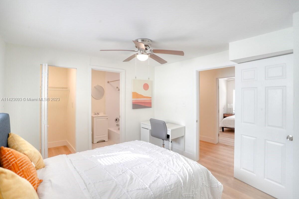 3632 Thomas Avenue Miami, FL 33133 - Photo 14 of 20 a bedroom with a bed and a chandelier