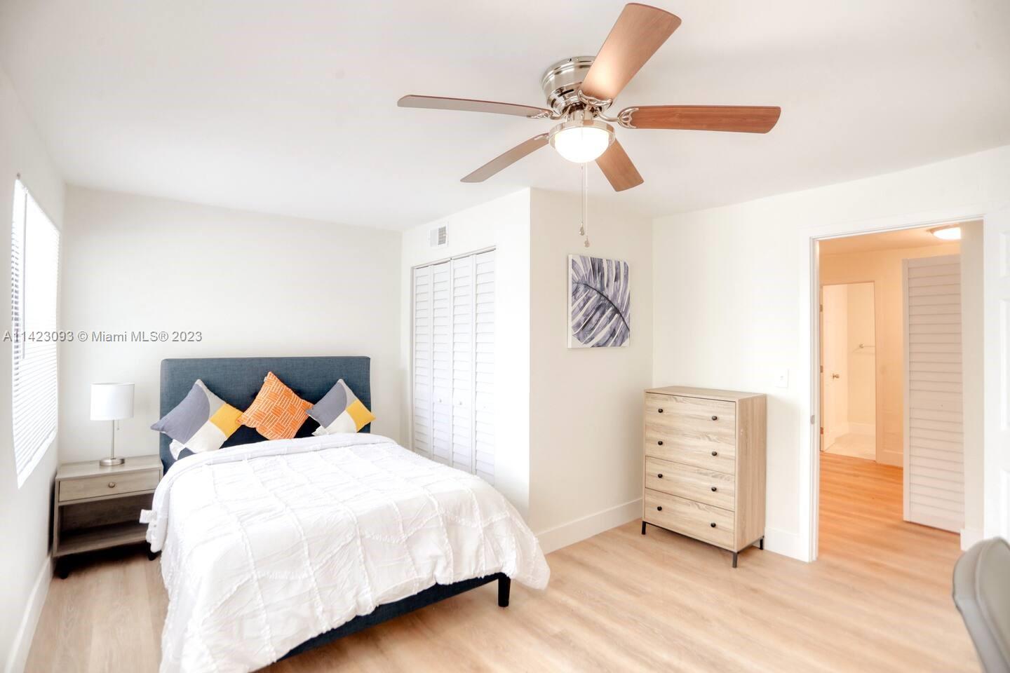 3632 Thomas Avenue Miami, FL 33133 - Photo 8 of 20 a bedroom with a bed and a chandelier