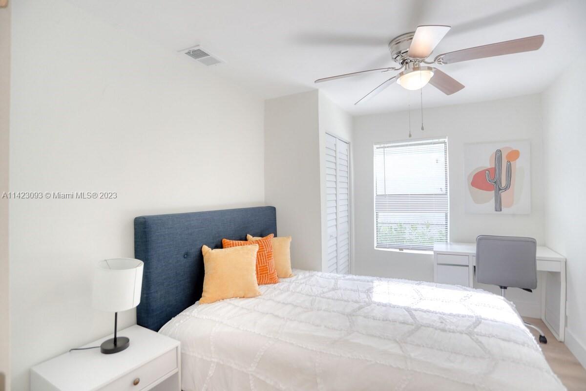 3632 Thomas Avenue Miami, FL 33133 - Photo 9 of 20 a bedroom with a bed and a chair
