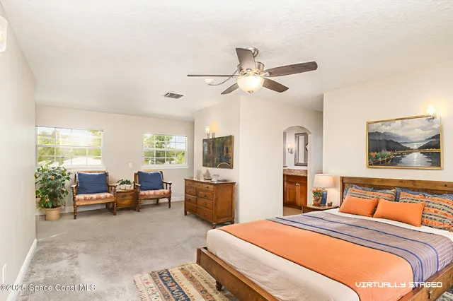 a kitchen with stainless steel appliances granite countertop a stove a refrigerator a sink a stove and white cabinets with wooden floor