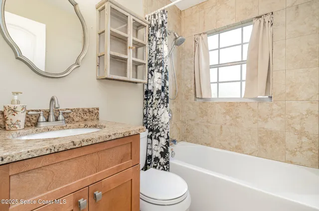 an empty room with fan and windows