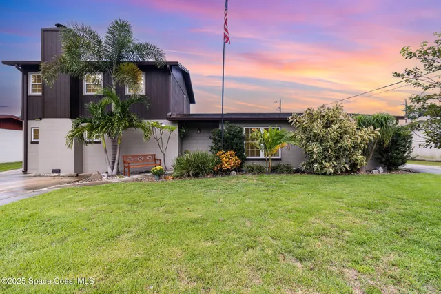 an aerial view of residential building with green space