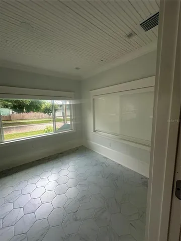 a view of an empty room with a window