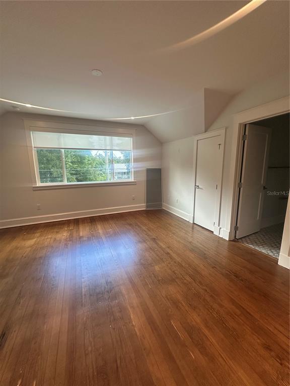 446 Ruth Lane Orlando, FL 32801 - Photo 20 of 45 an empty room with wooden floor and windows