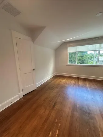 a view of wooden floor and windows in a room
