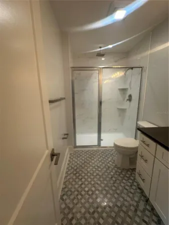 a bathroom with a sink a toilet and shower