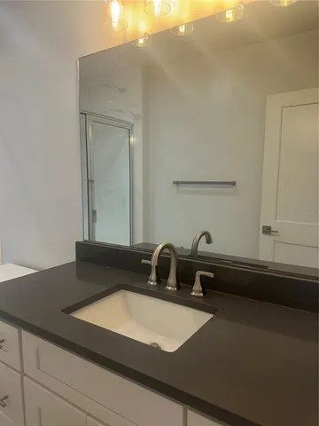 a bathroom with a sink a vanity and mirror