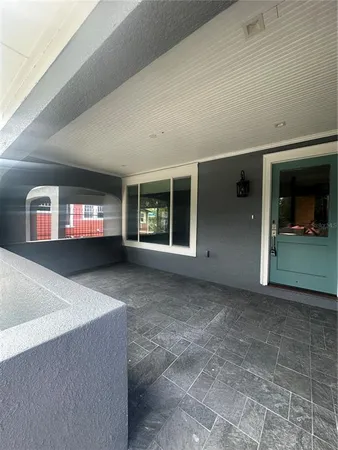 a living room with a large window and a flat screen tv