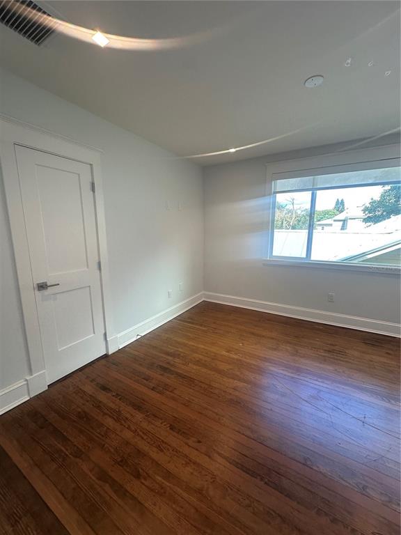 446 Ruth Lane Orlando, FL 32801 - Photo 32 of 45 an empty room with wooden floor and windows