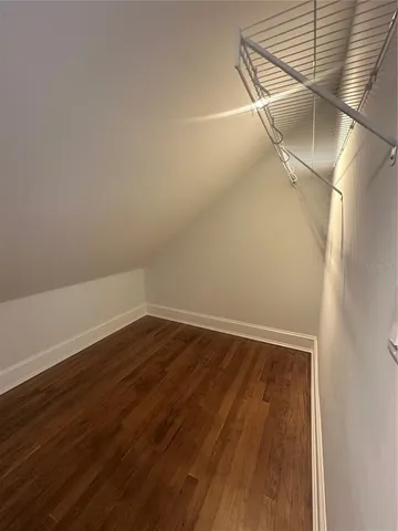 a view of a room with wooden floor