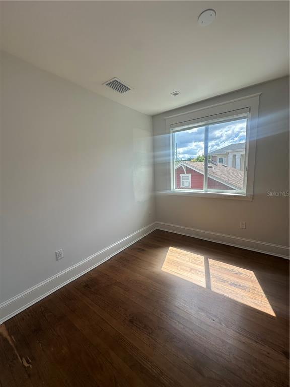446 Ruth Lane Orlando, FL 32801 - Photo 36 of 45 an empty room with wooden floor and windows