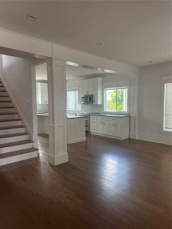 446 Ruth Lane Orlando, FL 32801 - Photo 8 of 45 an empty room with wooden floor and windows