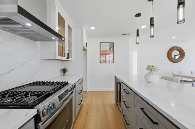 a kitchen with granite countertop a stove and a sink